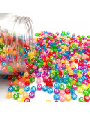 Letra blanca. Moneda transparente multicolor. 7 mm diámetro. 1,5 mm perforación. 100 uds aproximado.