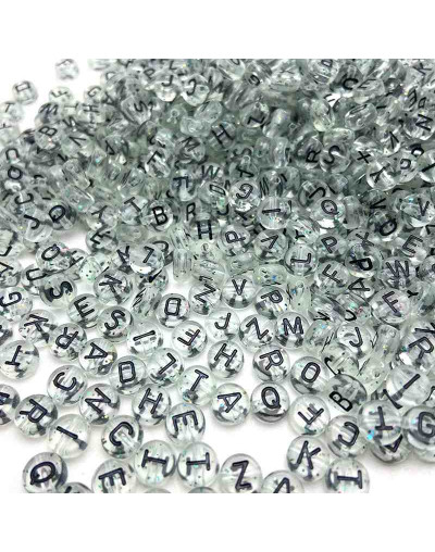 Letra negra. Moneda transparente. 7 milímetros diámetro. 1,5 mm perforación. 100 uds aproximado.