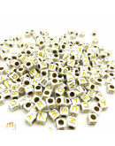 Letra dorada. Cubo blanco. 6 milímetros lado. 3 mm perforación. 100 uds aproximado.