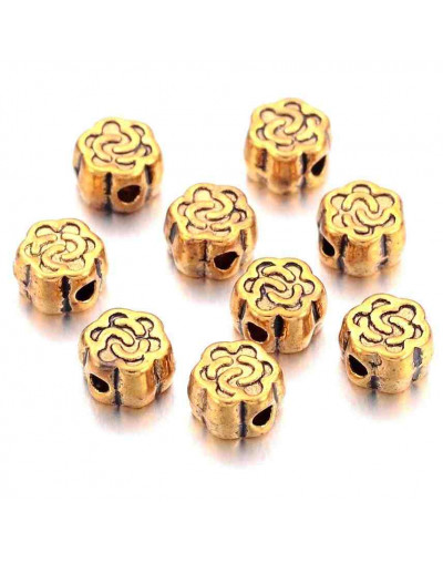 Flor. Aleación de cobre. Color oro antiguo. 4,5x3 milímetros. 1 mm perforación. 20 unidades