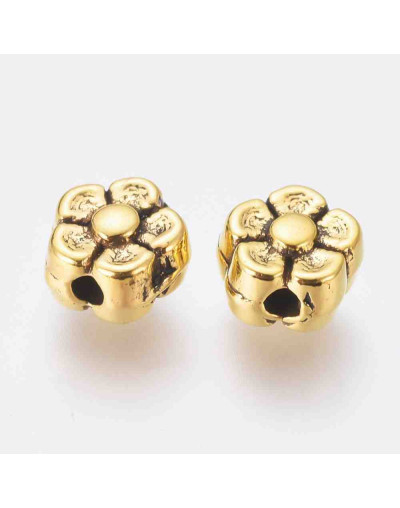 Flor. Aleación de cobre. Color oro antiguo. 5 mm diámetro. 1 mm perforación. 20 unidades.
