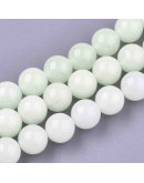 Piedra sintética. Fluorescente. 06 mm diámetro. 1 mm perforación. 65 unidades hilo (aproximado)