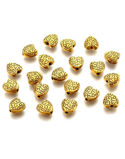 Corazón (7). Aleación de cobre. Color dorado antiguo. 9x9x4 mm. 1.5 mm perforación. 10 uds.