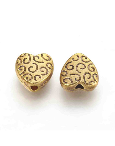 Corazón (7). Aleación de cobre. Color dorado antiguo. 9x9x4 mm. 1.5 mm perforación. 10 uds.