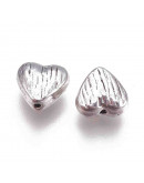 Corazón (5). Aleación de cobre. Color plata antigua. 8x8x4 mm. 1.5 mm perforación. 10 uds.