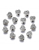 Corazón (6). Aleación de cobre. Color plata antigua. 6x6x3 mm. 1 mm perforación. 20 uds.