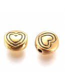 Corazón (1). Aleación de cobre. Color oro antiguo. 6x6x3 mm. 1,5 mm perforación. 20 unidades,