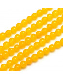 Jade Malaysia. Color amarillo. 06 mm diámetro. 0,8 mm perforación. 60 unidades hilo (aproximado).