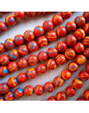 Malaquita sintética. Tonos rojos. 10 mm diámetro. 1 mm perforación. 35 uds hilo (aproximado).