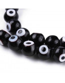 Ojo turco. Esfera. Color negro. 08 milímetros diámetro. 1 mm perforación. 45 unidades hilo (aprox.) Ojo turco. Esfera. Color negro. 08 milímetros diámetro. 1 mm perforación. 45 unidades hilo (aprox.)