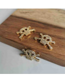 Calavera. Aleación+Zirconia. Baño 18KGold. 15x14x2 milímetros. 1,5 mm perforación. 1 unidad. Calavera. Aleación+Zirconia. Baño 18KGold. 15x14x2 milímetros. 1,5 mm perforación. 1 unidad.