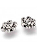 Nudo tibetano. Aleación de cobre. Color plata antigua. 7x10x3,5 mm. 1 mm perforación. 20 unidades.