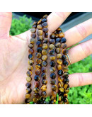 Ojo de Tigre. Moneda faceteada. 6x4 milímetros. 1 mm perforación. 55 uds hilo aprox. 1 hilo.