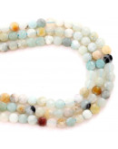 Amazonita. Moneda faceteada. 6x4 milímetros. 1 mm perforación. 55 uds hilo aprox. 1 hilo.