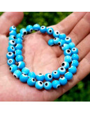 Ojo turco. Esfera. Color Celeste. 06 mm diámetro. 1 mm perforación. 60 uds hilo aprox. 1 hilo. Ojo turco. Esfera. Color Celeste. 06 mm diámetro. 1 mm perforación. 60 uds hilo aprox. 1 hilo.