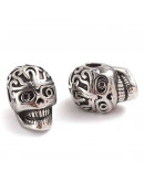 Calavera (3). Acero inoxidable. Color platedo. 11,2x7,8,5x9 mm. 2,4 mm perforación. 1 unidad.