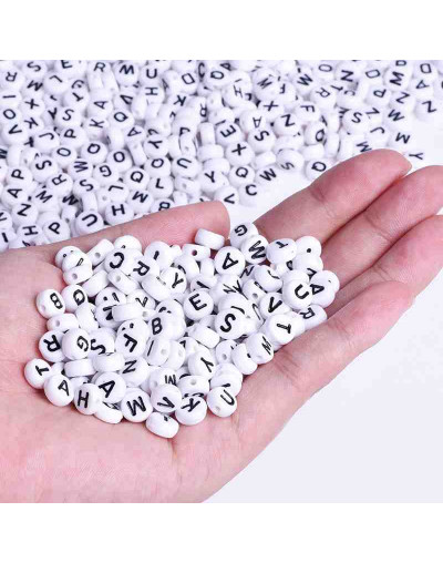 Letra negra. Moneda blanca. 7 milímetros diámetro. 1,5 mm perforación.3900 uds aprox. 500 gramos.