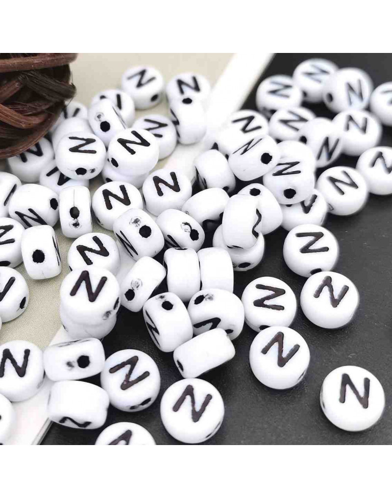 Letra negra. Moneda blanca. Letra "N". 7 mm diámetro. 1,5 mm perforación. 100 uds. aproximado. Letra negra. Moneda blanca. Letra "N". 7 mm diámetro. 1,5 mm perforación. 100 uds. aproximado.