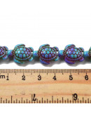 Howlite sintético. Tortugas. Color mauve. 17x14x7.5 mm. 1,6 mm perforación. 22 uds hilo aprox.